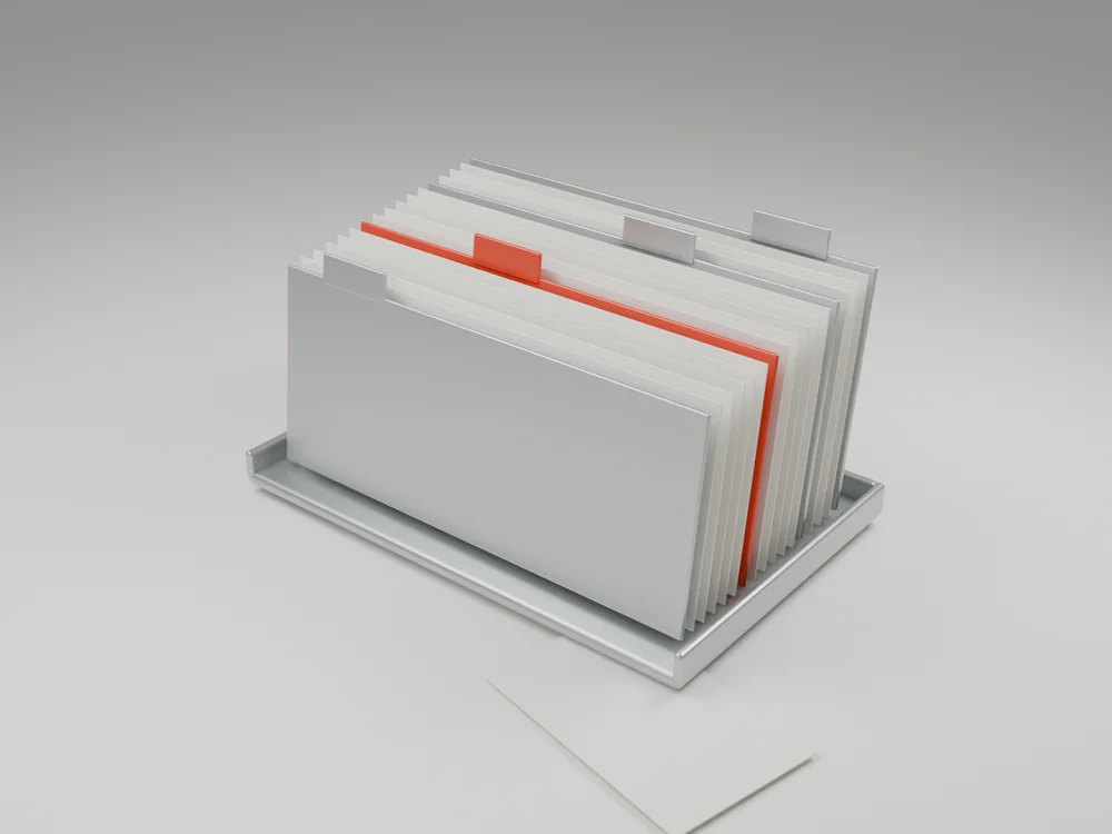 A physical archive of experiment cards with a red index divider